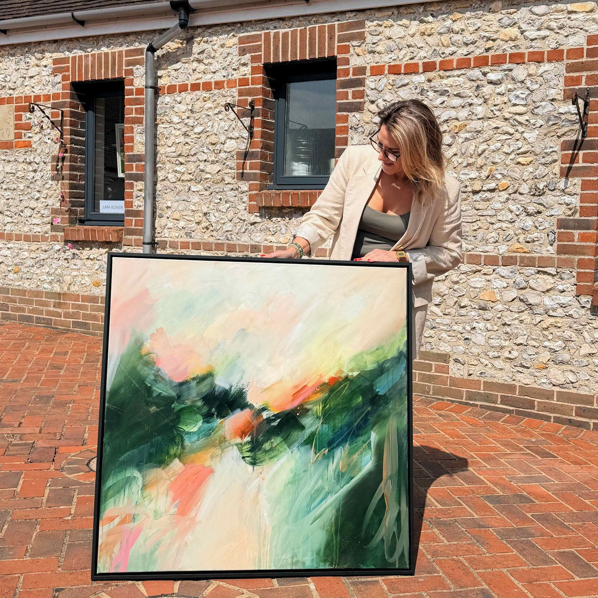 Joanna Gilbert with Aura, original abstract painting in a black float frame at the Arundel Art Trail
