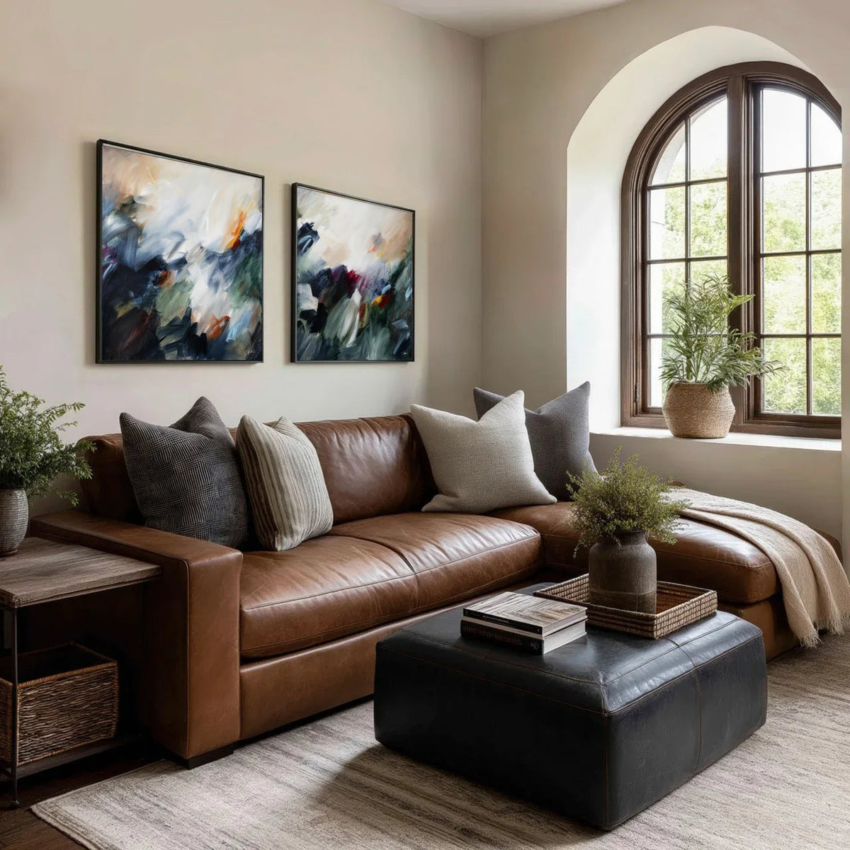 The Turning Point pair, two abstract framed canvas prints by Joanna Gilbert above a leather sofa in a living room