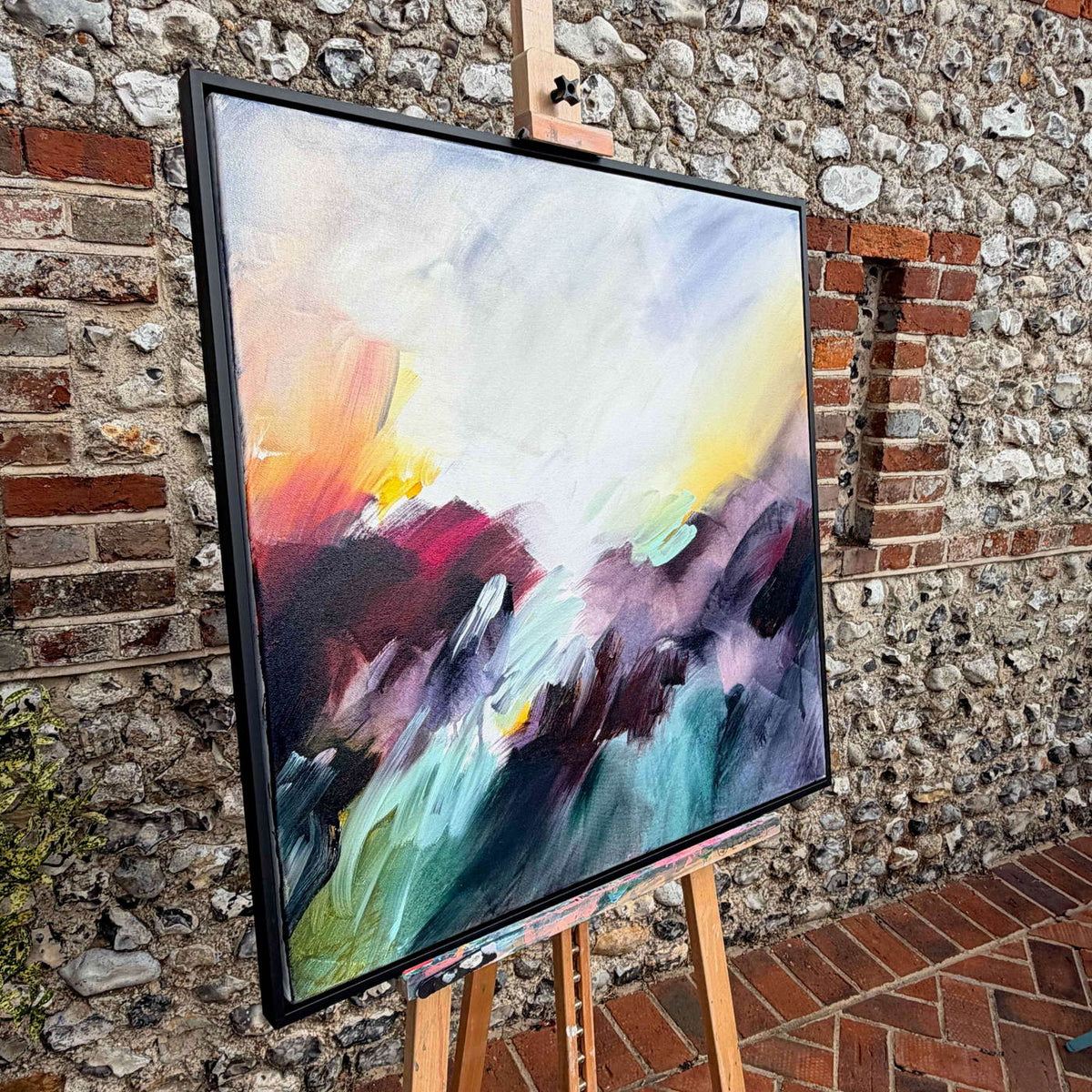 Where the Light Finds You by Joanna Gilbert, framed original on an easel against a flint studio wall