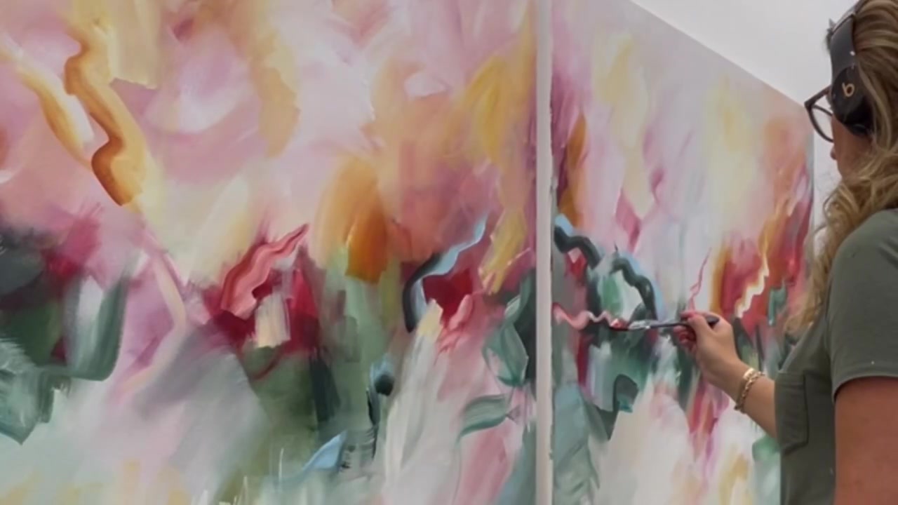 Joanna Gilbert painting an abstract canvas in her studio