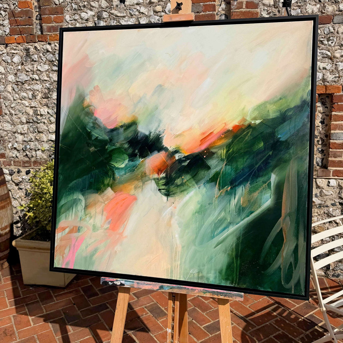 Aura by Joanna Gilbert, framed original painting on an easel against a flint studio wall
