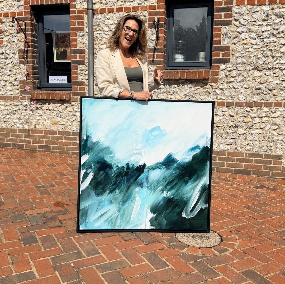 Joanna Gilbert with Beneath the Surface, original abstract painting in a black float frame at the Arundel Art Trail