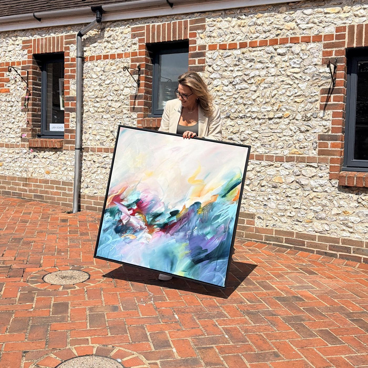 Joanna Gilbert holding Dreaming in Colour, original abstract painting, at the Arundel Art Trail