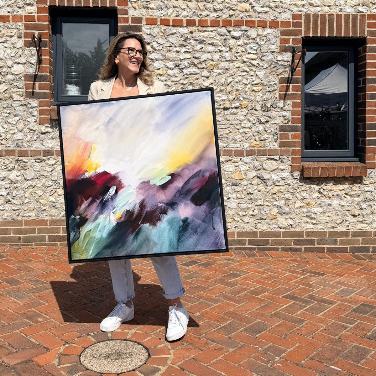 Joanna Gilbert holding Where the Light Finds You, original abstract painting at the Arundel Art Trail